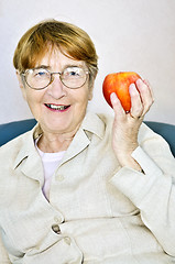 Image showing Elderly woman with apple