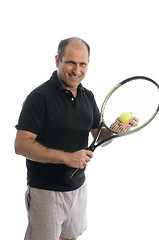 Image showing active senior man playing tennis with beer belly