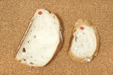 Image showing Two slices of bread pinned to corkboard