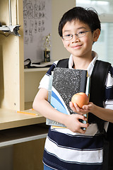 Image showing Studying kid with an apple