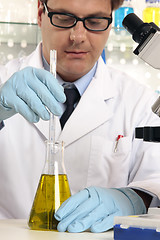 Image showing Scientist mixing liquids chemicals