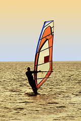 Image showing Silhouette of a windsurfer on waves of a sea 