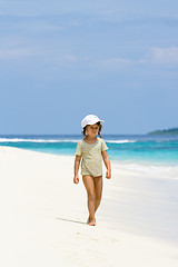 Image showing A young girl walking on the beach