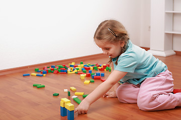 Image showing Adorable girl playing with blocks