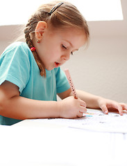 Image showing Cute little girl painting at home