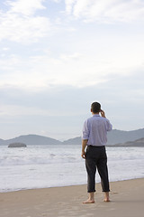 Image showing Businessman standing on beach