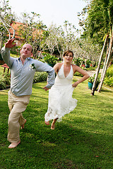 Image showing Bride and groom jumping.