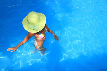 Image showing Young woman  in a swimming pool