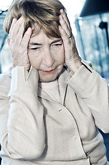 Image showing Elderly woman holding head