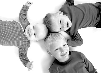 Image showing Three children lying on the floor