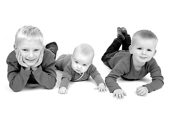 Image showing Three children lying on the floor