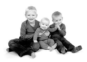 Image showing Three children sitting on the floor