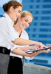 Image showing two happy businesswomen with paper chart