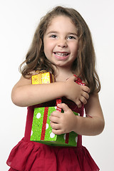 Image showing Jovial happy girl child holding presents