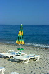 Image showing Folded umbrella on a beach