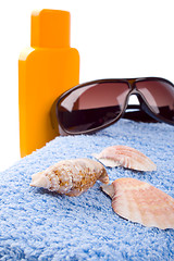 Image showing towel, shells, sunglasses and lotion