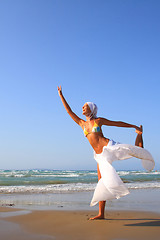 Image showing Beautiful girl meditating on the beach