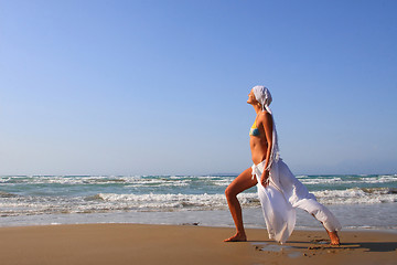 Image showing Beautiful girl meditating on the beach