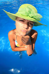 Image showing Young woman enjoying a swimming pool