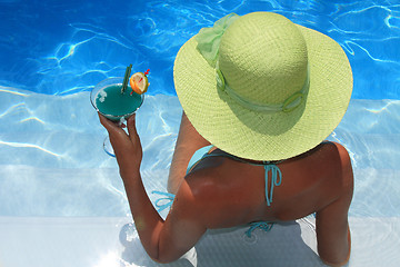 Image showing Woman lying in blue pool