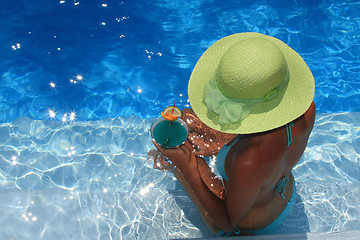 Image showing Woman lying in blue pool