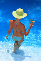 Image showing Woman standing  in blue pool