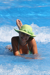 Image showing Young woman enjoying a swimming pool