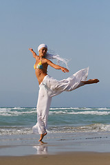 Image showing Beautiful young woman jumping on a beach in Greece