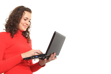 Image showing young smiling girl using a laptop
