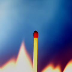 Image showing Match surrounded by flame against blue background