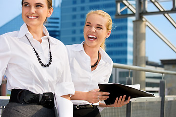 Image showing two happy businesswomen with folders