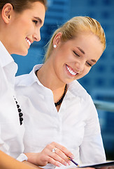 Image showing two happy businesswomen with papers