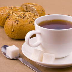 Image showing cup of tea, sugar and bread