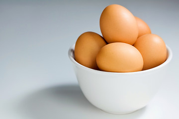 Image showing Fresh Brown Eggs in White Bowl On Blue Gray