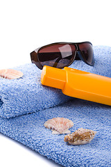 Image showing towel, shells, sunglasses and lotion