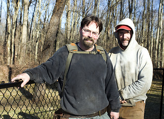 Image showing two workmen repairing chain link fence