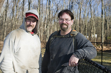 Image showing two workmen repairing chain link fence 