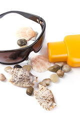 Image showing sunglasses, shells and lotion