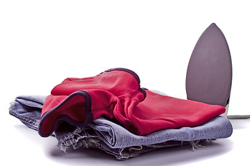 Image showing iron and pile of clothes