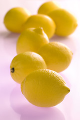 Image showing lemons on violet reflecting background