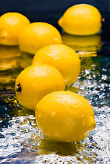 Image showing lemons on thin layer of water