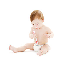 Image showing baby boy in diaper with toothbrush