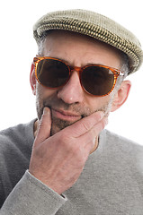 Image showing aging artist thinking distorted nose close up scottish tweed hat