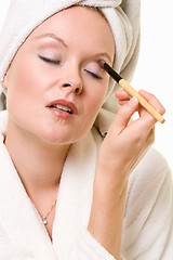 Image showing Putting on eye makeup