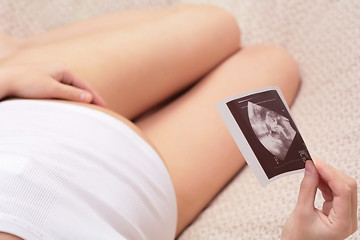 Image showing  pregnant woman and ultrasound pictures