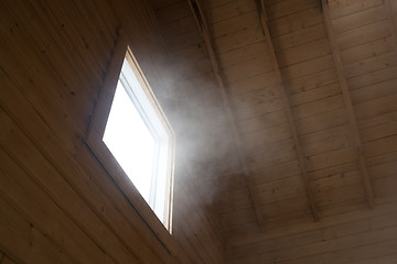Image showing Light and steam coming through a window
