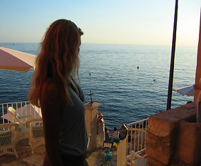 Image showing blond women starring at the ocean