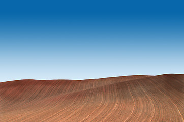 Image showing Ploughed field with blue sky