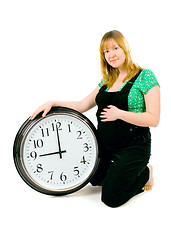 Image showing pregnant woman with a clock