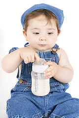 Image showing Sitting baby with milk